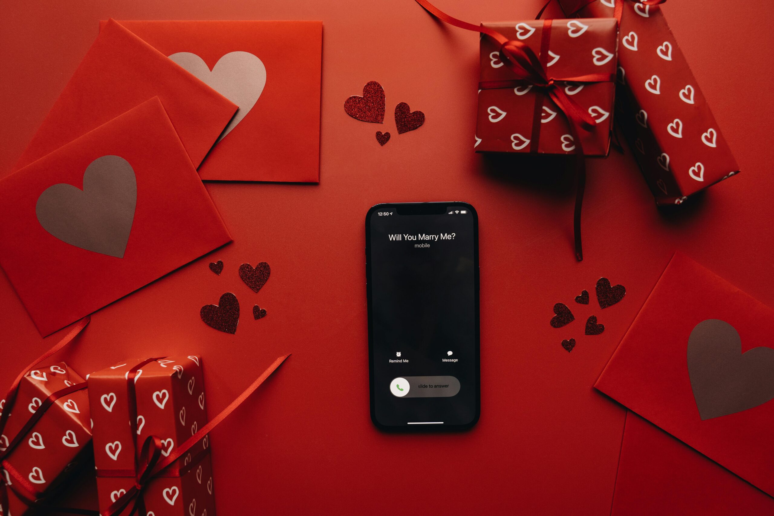 A romantic proposal scene featuring gifts, red envelopes, and a 'Will You Marry Me?' phone call.